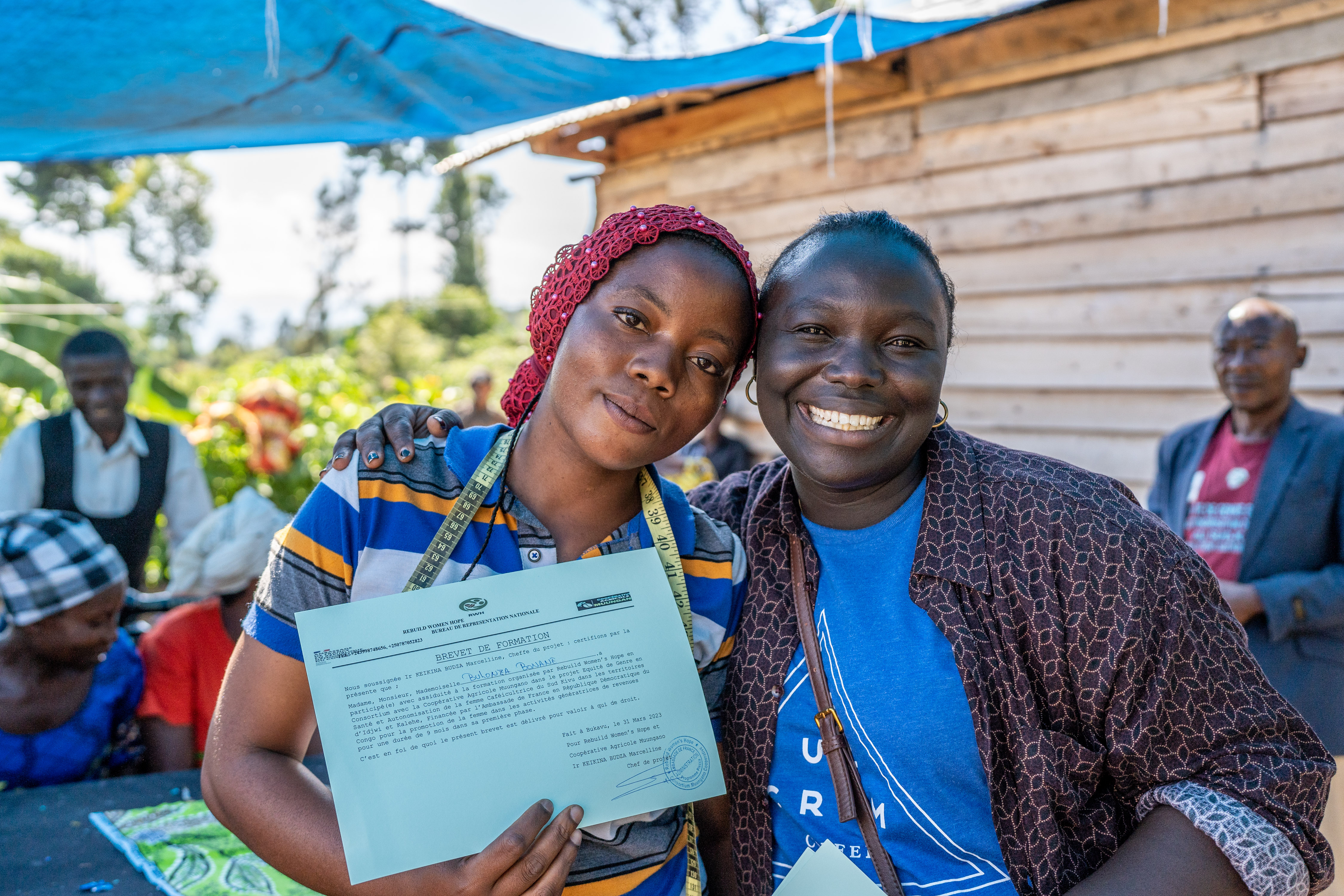 Marcelline handing out certificates of accomplishment